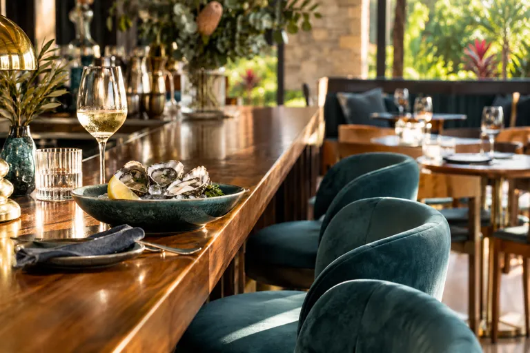 Oysters and stemware on a timber bar counter