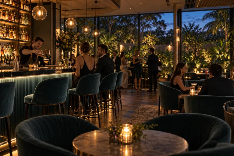 Bar at dusk with adult guests and garden views through the windows